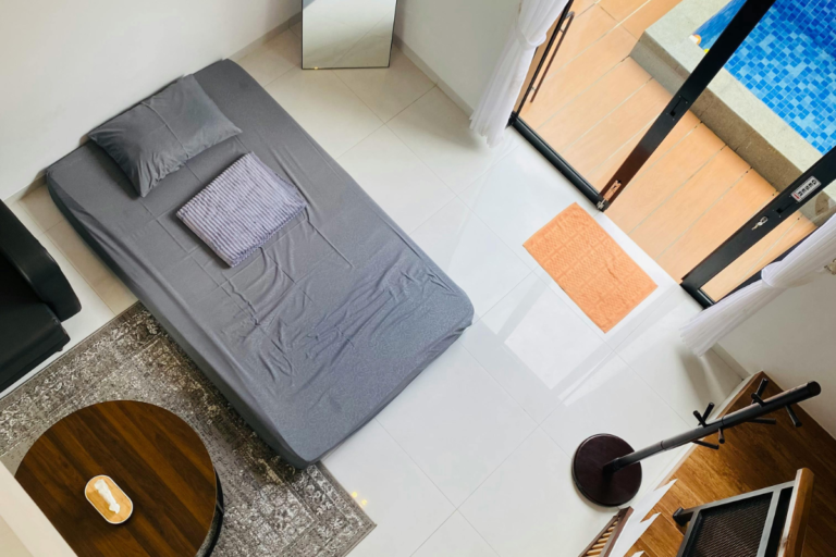 Minimalist Airbnb bedroom with clean bed, natural light, and simple layout designed for comfort and relaxation