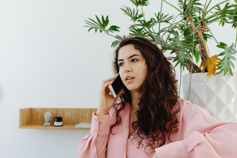Airbnb guest speaking on the phone about booking concerns and host communication