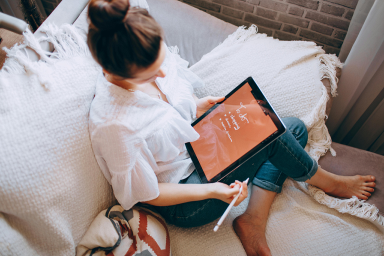 Person using a tablet to plan a vacation for a relaxing and intentional getaway