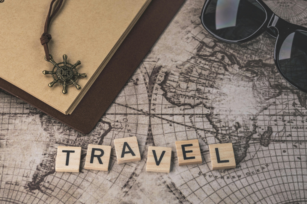 Travel planning essentials on a world map representing hidden travel costs and smart vacation budgeting