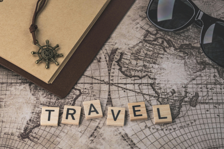Travel planning essentials on a world map representing hidden travel costs and smart vacation budgeting